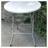 Round Folding Cocktail Table (2/2) | Round folding cocktail table with a white tabletop and gray ste