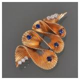 DIAMOND, SAPPHIRE, & 14K GOLD RIBBON FORM PIN | Textured yellow gold ribbon-form pin set with 2 stat