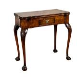 A GEORGE II INLAID GAMES TABLE | Having burlwood veneer with felt lined flip-top with dish corners, 