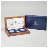 UNITED STATES CONSTITUTION COINS SET | A four-coin set in a mahogany presentation box, including 2 1