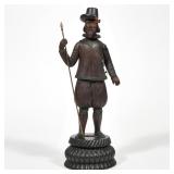 BLACK FOREST CARVED FIGURE OF A MAN WITH SPEAR | showing a standing bearded hunstman figure on a fin