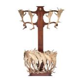 ANTLER MOUNTED COAT RACK / HALL TREE | 20th century, having four antlers mounted as coat hooks on sc