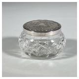 GORHAM CUT CRYSTAL JAR WITH SILVER-PLATED TOP | Small, circular cut crystal jar. Features repoussé s
