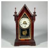 WOODEN STEEPLE-FORM SHELF CLOCK WITH ALARM, JEROME & CO. | Shelf clock with burlwood case with arch 