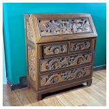 CHINESE STYLE SLANT LID DESK | Deeply carved with figures engaged in a village setting having a fall