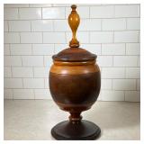 Turned Wood Lidded Pedestal Urn | Having smooth wood in two tones and tall finial on lid. Dimensions