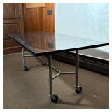 INDUSTRIAL STAINLESS STEEL BASE TABLE WITH BLACK POLISHED GRANITE TOP ON CASTERS