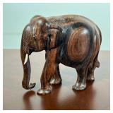 CARVED HARDWOOD ELEPHANT WITH INLAID EYES AND TUSKS