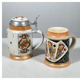 #32 PAIR OF PLAYING CARD MOTIF CERAMIC BEER STEINS | Two ceramic beer steins decorated with polychro