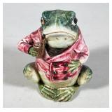 #35 FIGURAL FROG JAR HOLDING PIPE, GLAZED EARTHENWARE | Polychrome glazed earthenware figural jar mo