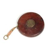 JOHN RABONE & SONS LEATHER-CASED TAPE MEASURE WITH BRASS WINDING | Round leather-cased tape measure 