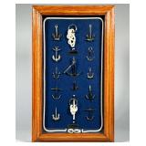 FRAMED SHADOWBOX OF MINIATURE NAUTICAL ANCHORS | Shadowbox of multiple small metal anchor models mou