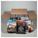 ASSORTED LOT OF DVDs AND CDs | Assorted lot of commercial DVDs and audio CDs presented in a corrugat
