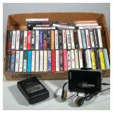 (3pc) LOT OF ASSORTED AUDIO CASSETTES WITH TWO SONY WALKMAN FM/AM CASSETTE PLAYERS | Cardboard box c