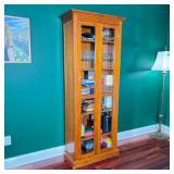 WOOD AND GLASS CURIO DISPLAY CABINET | Tall wood display cabinet with paired glazed doors and a mold