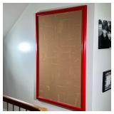 LARGE RED FRAMED CORK BULLETIN BOARD | Large rectangular cork bulletin board mounted within a vibran