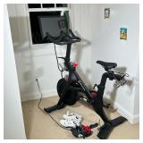 PELOTON INDOOR STATIONARY BIKE WITH TWO PAIRS OF CYCLING SHOES | Black Peloton-branded indoor statio