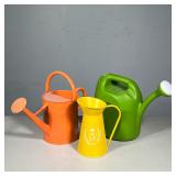 (3pc) SET OF THREE WATERING CANS, TWO METAL AND ONE PLASTIC | Three watering cans: two painted metal