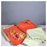 ASSORTED TABLE LINENS: ORANGE EMBROIDERED RUNNER & 12 PLACEMATS, 7 SAGE PLACEMATS, GOLD TABLECLOTH |