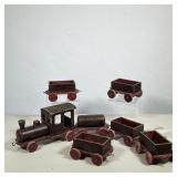 (6pc) VINTAGE SEVEN-PIECE PAINTED WOODEN TOY TRAIN SET | This seven-piece toy train set is construct