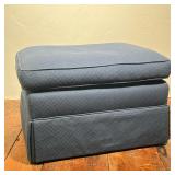 CONTEMPORARY BLUE UPHOLSTERED SKIRTED OTTOMAN | Upholstered in a blue woven fabric featuring a repea