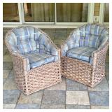 (2pc) PAIR OF WOVEN RATTAN BARREL BACK ARMCHAIRS WITH CUSHIONS | A pair of barrel-back armchairs fea