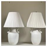 PAIR OF WHITE GLAZED CERAMIC AMPHORA FORM TABLE LAMPS | A pair of table lamps featuring white glazed