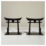 JAPANESE PATINATED BRONZE RYOBU TORII GATE BOOKENDS | A pair of patinated bronze bookends modeled as