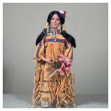 NATIVE AMERICAN STYLE PORCELAIN DOLL | The doll features a porcelain head and hands with black synth