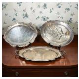 THREE ASSORTED SILVERPLATE SERVING PLATTERS AND HANDLED TRAY