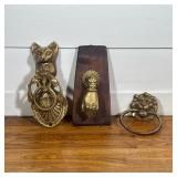 (3pc) THREE VINTAGE BRASS DECORATIVE ITEMS INCLUDING TWO DOOR KNOCKERS AND A LION RING