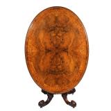LOT 70 | REGENCY BURLWOOD INLAID DINING TABLE | Having an oval tilt top with marquetry border and br