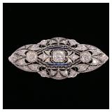 LOT 114 | ART DECO DIAMOND & SAPPHIRE PLATINUM PIN | Openwork platinum pin with yellow gold stick/fa