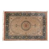 LOT 170 | PERSIAN SILK RUG | Mid 20th century, possibly Nain, with a circular medallion on a beige g