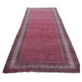 LOT 331 | ANTIQUE FERRAGHAN CORRIDOR CARPET | Having a red field with overall boteh pattern h. 19 ft