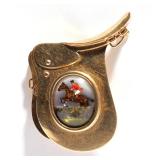 LOT 486 | REVERSE PAINTED INTAGLIO PIN | The pin designed as a 14k gold horse saddle with a central 