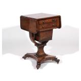 LOT 523 | REGENCY ROSEWOOD DROP-SIDE SEWING TABLE | Having two drawers over pull-out sewing basket, 