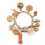 LOT 105 | 14K GOLD CHARM BRACELET | A 14k yellow gold chain link bracelet marked "DFS" with 14k, 10k