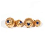 Designed as two 18k yellow gold graduated ribbed domes, each set with a cabochon sapphire and connec