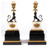 Each with a bronze sphinx above a white onyx plinth with ormolu mounts on an ebonized base, mounted 