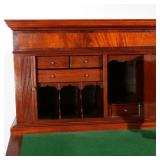 Circa 1830, having molded cornice over full-width drawer, over two tambour doors centering a cabinet