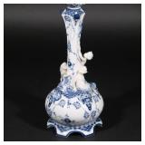 centering a single candle holder, on a base decorated with putti and snails, no. 1 / 1006 h. 21-1/2 
