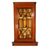 Having vitrine top with through muntins, over cabinet door with conch shell and line inlay in contra