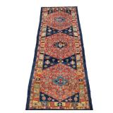 LOT 298 | CAUCASIAN CORRIDOR RUG | With three medallions on a red field, within patterned yellow, bl