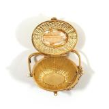 18k yellow gold basket pendant with hinged lid, signed on the bottom "DKE" and ed. 19/200, having a 