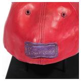 Baseball Cap Ceramic With "R" monogram, signed on the back, on a black metal stand h. 4-1/4 w. 7 d. 