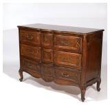 LOT 416 | LOUIS XV-STYLE CARVED WALNUT COMMODE | 20th century, having three drawers with serpentine 