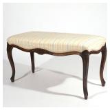 Lot 618  |  FRENCH CARVED OAK WINDOW BENCH  |  20th century, in the Louis XV style with a striped pa