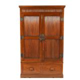 section with two cabinet doors, the lower section with two side-by-side drawers over a sculpted apro