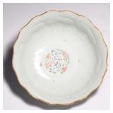 lobed "chrysanthemum" shape, decorated throughout with various flowers, the interior with a medallio